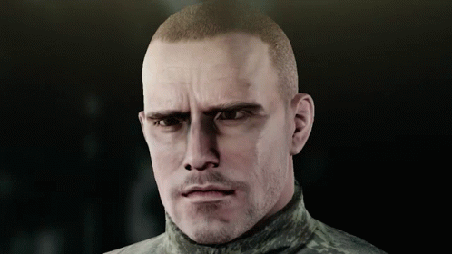 A Man With A Shaved Head And A Beard Looks At The Camera GIF