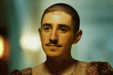 a man with a shaved head and a mustache is wearing a dress