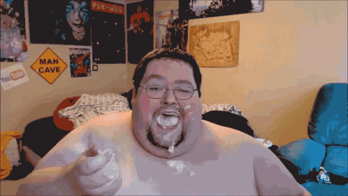 A Man With A Sign That Says Man Cave In The Background GIF