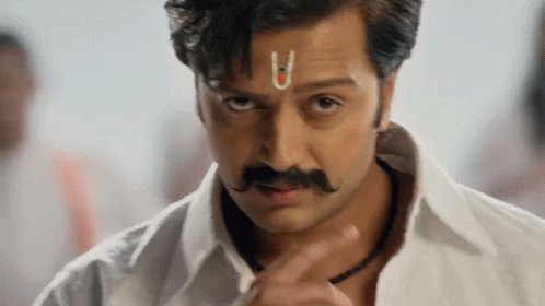 A Man With A Small U On His Forehead Looks At The Camera GIF