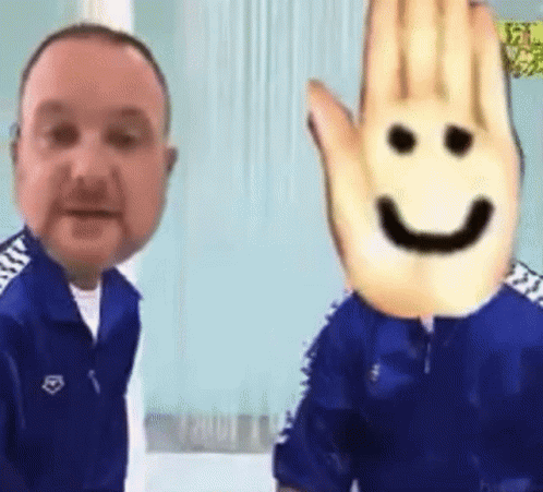 A Man With A Smiley Face On His Face Is Standing Next To Another Man . GIF