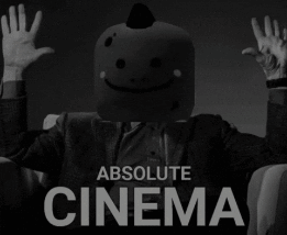 A Man With A Smiley Face On His Head Is Sitting In A Chair With His Hands In The Air And The Words Absolute Cinema Below GIF
