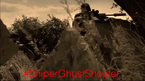 A Man With A Sniper Rifle In A Field With #Sniperghostshooter Written In Red GIF