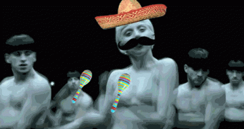 A Man With A Sombrero On His Head And A Mustache Is Surrounded By Other Men GIF