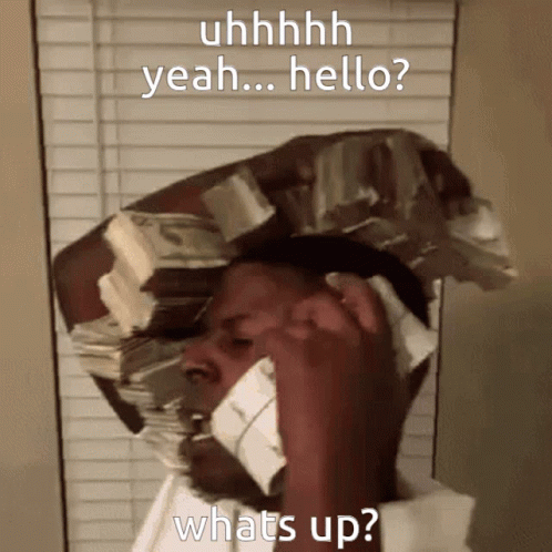 A Man With A Stack Of Money On His Head Talking On A Phone GIF