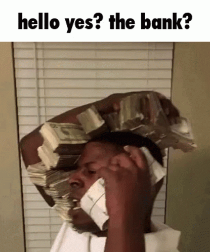 A Man With A Stack Of Money On His Head Talking On A Phone GIF
