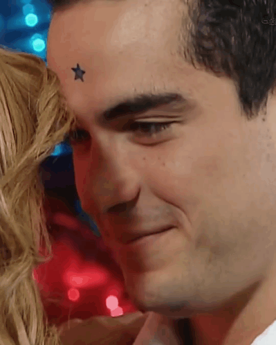 a man with a star on his forehead is smiling