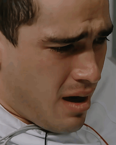a man with a stethoscope around his neck is crying