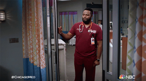 a man with a stethoscope around his neck is standing in a hospital room with the hashtag #chicagomed on the bottom