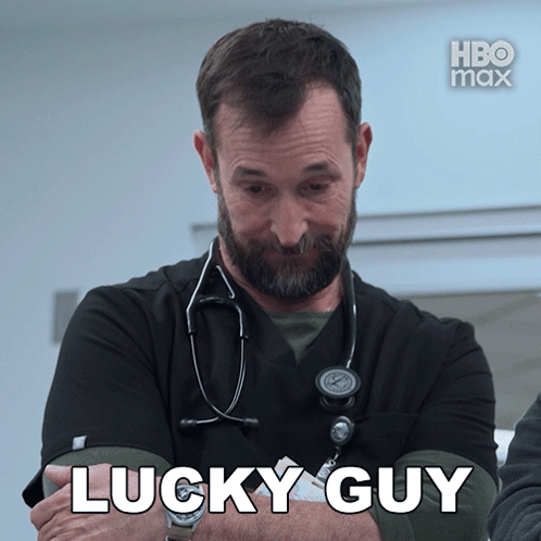 A Man With A Stethoscope Around His Neck Says " Lucky Guy " In White Letters GIF