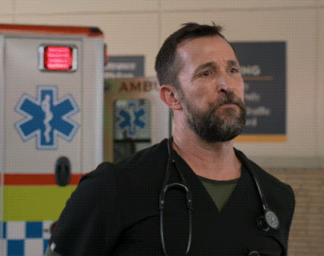 A Man With A Stethoscope Around His Neck Stands In Front Of An Ambulance GIF