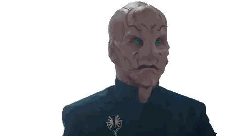 a man with a strange face and blue eyes is giving the ok sign
