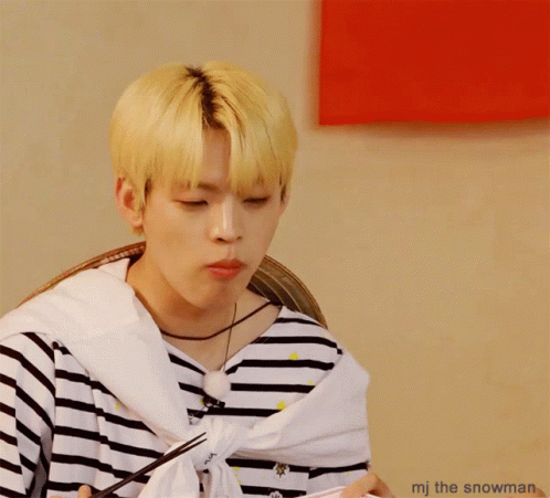 A Man With A Striped Shirt Is Eating Something With Chopsticks And The Words Mj The Snowman Below Him GIF