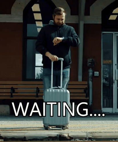 A Man With A Suitcase Is Looking At His Watch And The Word Waiting Is Behind Him GIF