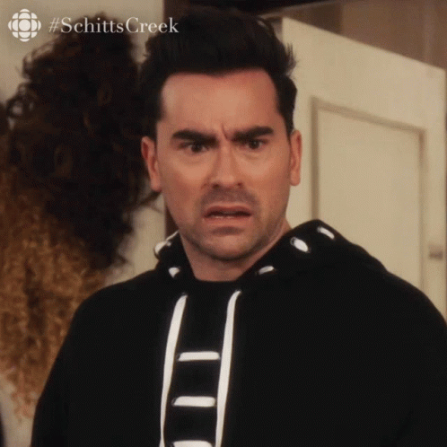 A Man With A Surprised Look On His Face And The Hashtag Schitts Creek GIF