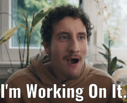 a man with a surprised look on his face and the words " i 'm working on it " below him