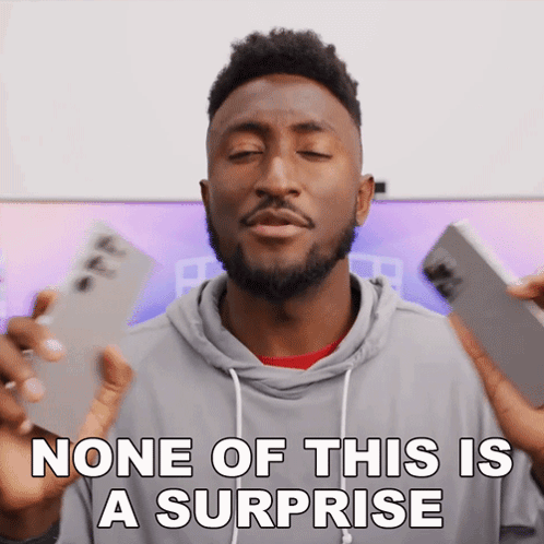 A Man With A Surprised Look On His Face And The Words None Of This Is A Surprise Below Him GIF