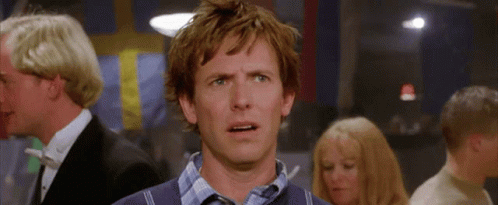 a man with a surprised look on his face is in a crowd of people