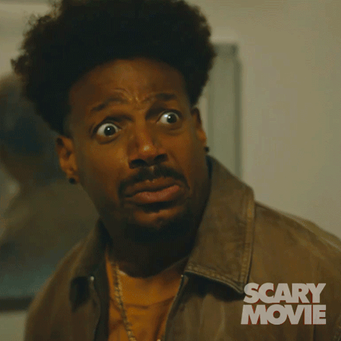 A Man With A Surprised Look On His Face Is In A Scary Movie Advertisement GIF