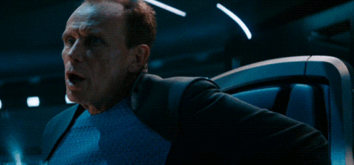 A Man With A Surprised Look On His Face Is Next To A Sign That Says Who GIF