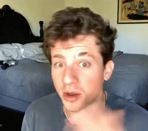 A Man With A Surprised Look On His Face Is Pointing At The Camera GIF