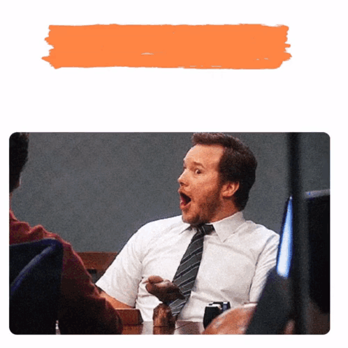 A Man With A Surprised Look On His Face Is Sitting At A Table GIF