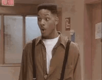 A Man With A Surprised Look On His Face Is Standing In A Hallway With The Word Rad Written On The Bottom . GIF