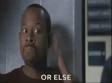 A Man With A Surprised Look On His Face Is Standing In Front Of A Wall . GIF