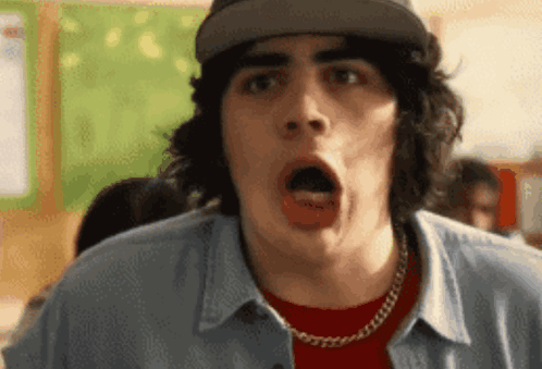 A Man With A Surprised Look On His Face Is Wearing A Hat GIF