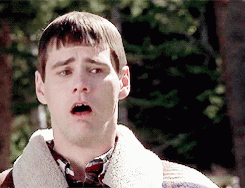 A Man With A Surprised Look On His Face Is Wearing A Sweater And Plaid Shirt GIF