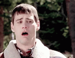 A Man With A Surprised Look On His Face Is Wearing A Sweater And Plaid Shirt GIF