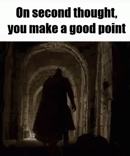 A Man With A Sword Is Walking Through A Dark Tunnel . GIF