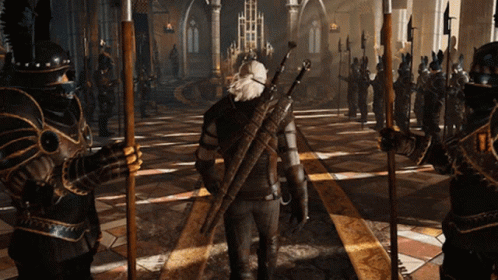 A Man With A Sword On His Back Stands In Front Of A Group Of Knights GIF
