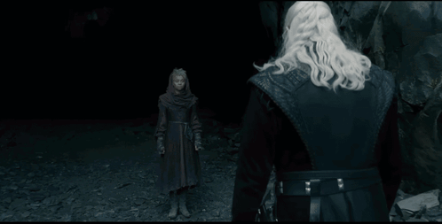 A Man With A Sword Stands In Front Of A Giant Monster GIF