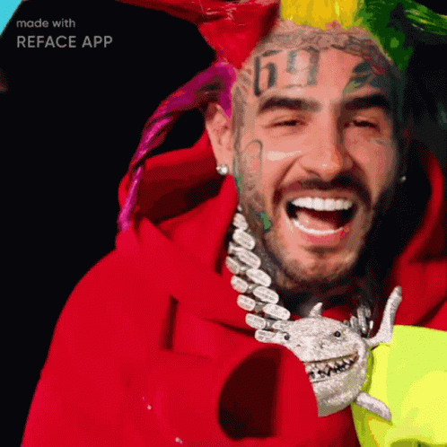 A Man With A Tattoo Of The Number 69 On His Face Is Smiling GIF