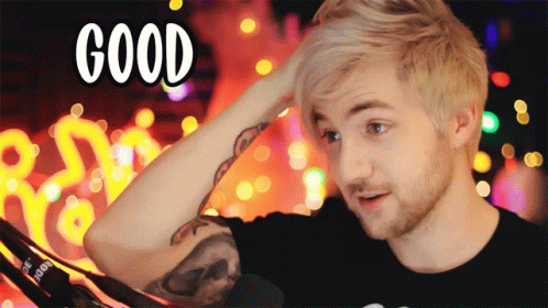 A Man With A Tattoo On His Arm Holds His Hand To His Head With The Word Good Above Him GIF