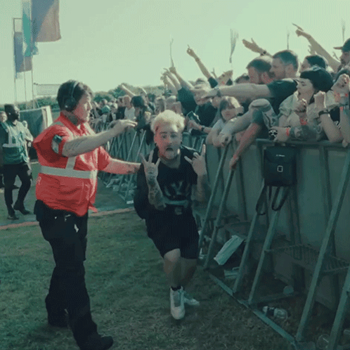 a man with a tattoo on his arm is being escorted by a security officer