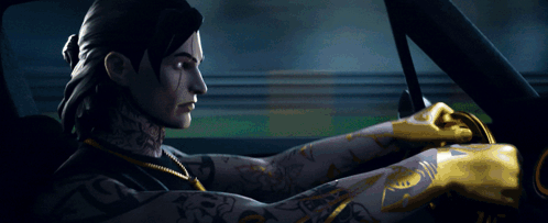 A Man With A Tattoo On His Arm Is Driving A Car At Night GIF