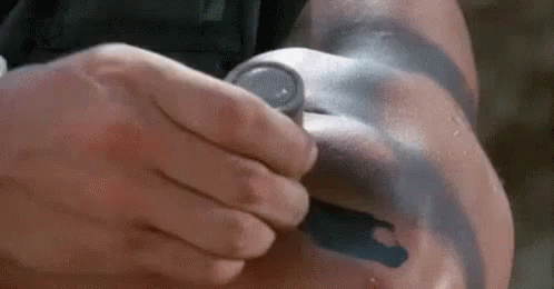A Man With A Tattoo On His Arm Is Holding A Stethoscope . GIF