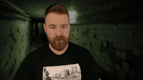 A Man With A Tattoo On His Arm Is Wearing A Black Shirt With A Picture Of A Sheep On It GIF