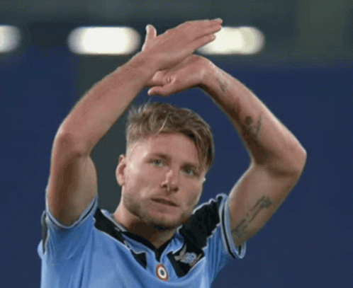 A Man With A Tattoo On His Arm Is Wearing A Blue Shirt With The Word Jeep On It GIF