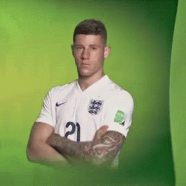 a man with a tattoo on his arm is wearing a white jersey with the number 21 on it
