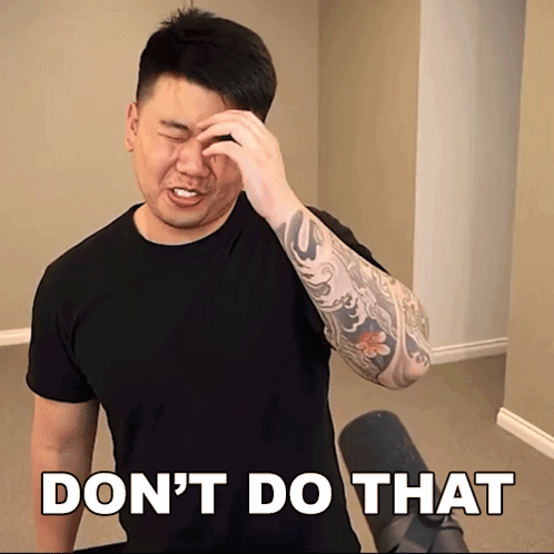 A Man With A Tattoo On His Arm Wipes His Forehead In Front Of A Sign That Says Do N't GIF
