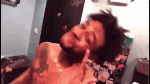 A Man With A Tattoo On His Chest Is Giving The Middle Finger GIF