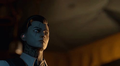 A Man With A Tattoo On His Face Is Looking At Something In A Dark Room GIF