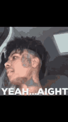 A Man With A Tattoo On His Face Is Sitting In A Car And Says Yeah ... Aight GIF