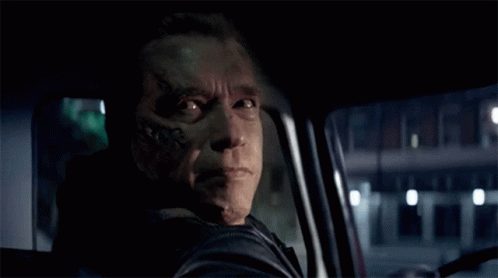 A Man With A Tattoo On His Face Is Smiling While Driving A Car GIF