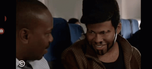 A Man With A Tattoo On His Face Is Smiling With A Copyright Symbol In The Corner GIF
