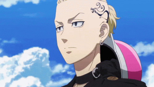 A Man With A Tattoo On His Forehead Holds A Pink Helmet GIF
