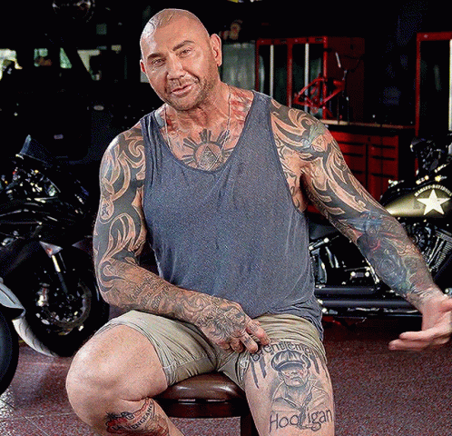 A Man With A Tattoo On His Leg That Says Hooligan On It GIF